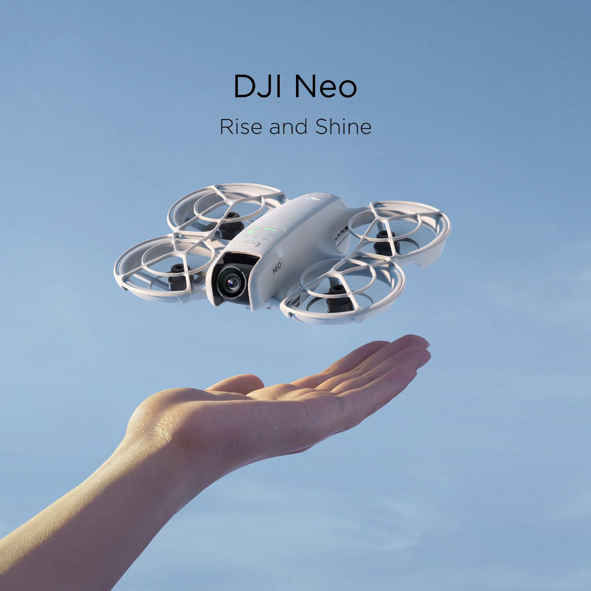 An outstretched hand launches a DJI Neo against a blue sky.