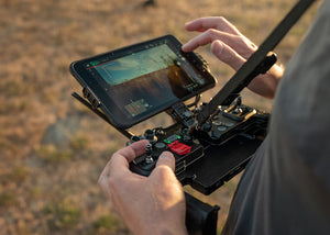 A person useing the Freefly Astro controller outdoors